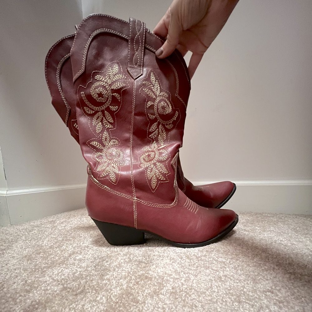 Dark red cowboy boots with tan embroidery.